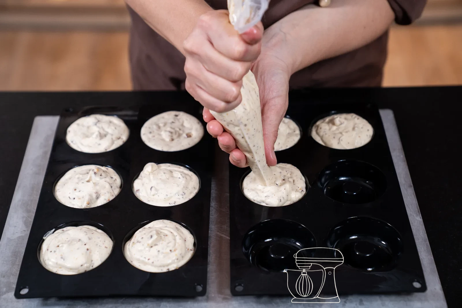 Parfait mixture being piped into the donut silicone mold with the piping bag