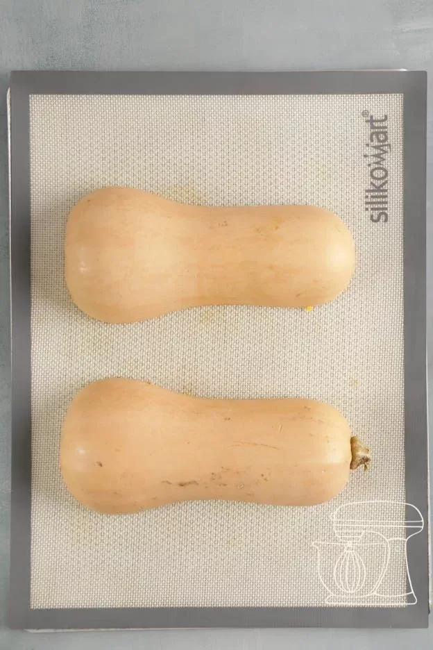 Squash halves cut side down on the perforated tray