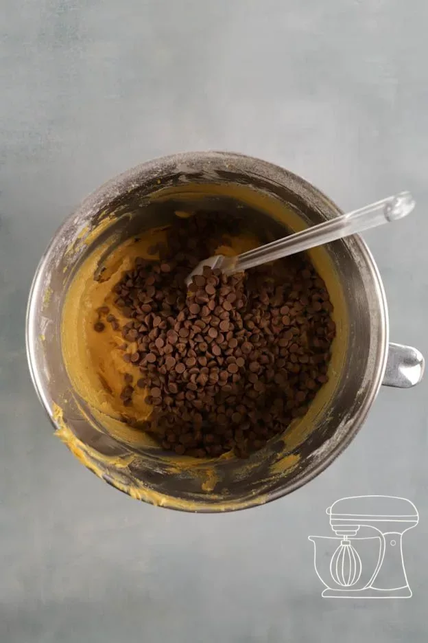 Chocolate drops are folded in with the dough scraper