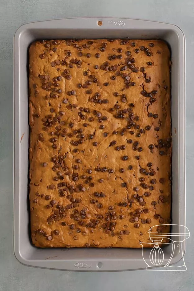 Brownie being turned out onto a tray with baking paper