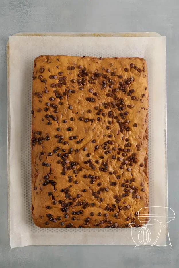 Chocolate lines being piped over the brownie
