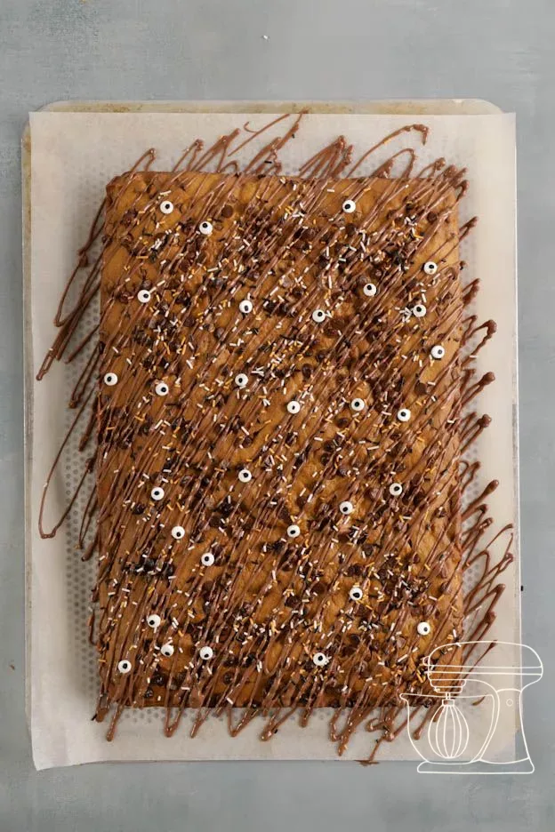 Decorated pumpkin brownies ready to be cut