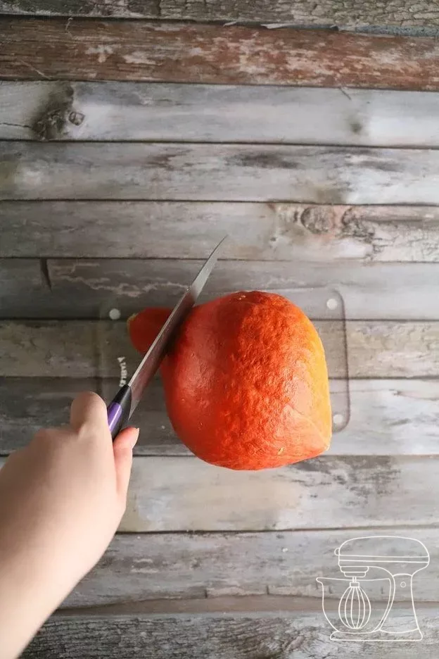 Hokkaido squash being peeled and cut into pieces