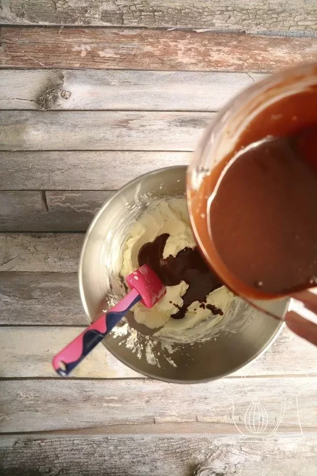 Creamy whipped cream being folded into the ganache