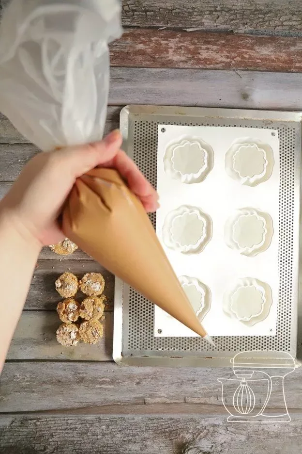 Pumpkin mousse being filled into a large Piping bag