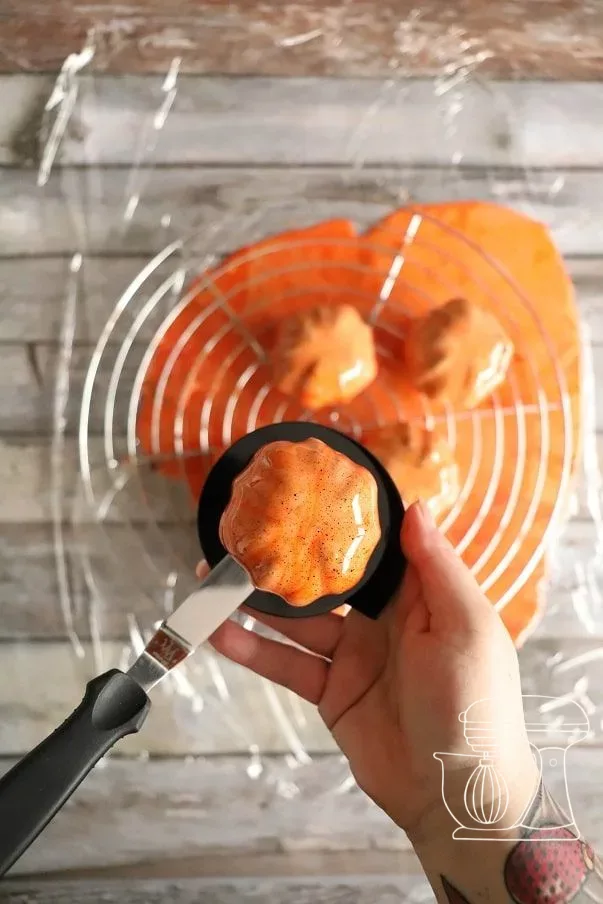 Glazed tartlet being placed onto a cake board with the Angled spatula