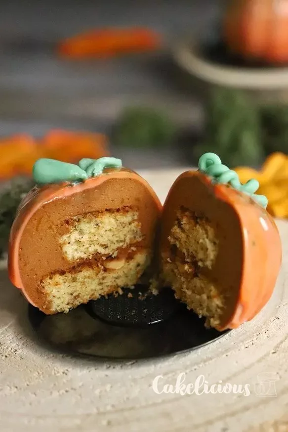 Pumpkin mousse tartlets with orange mirror glaze and stems made of Modeling chocolate