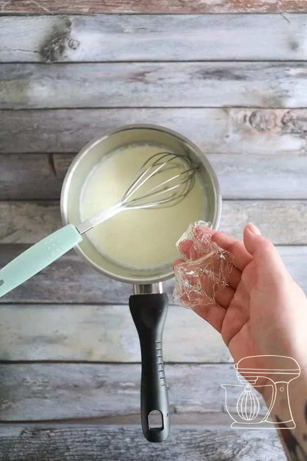 Hot cream being poured over the dark couverture
