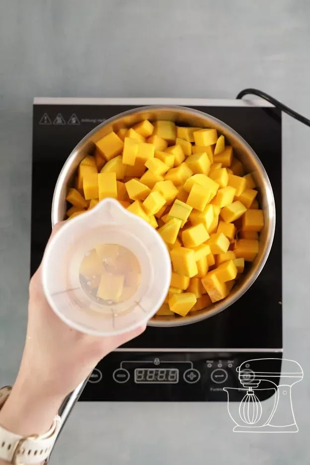 Water being added to the pumpkin cubes
