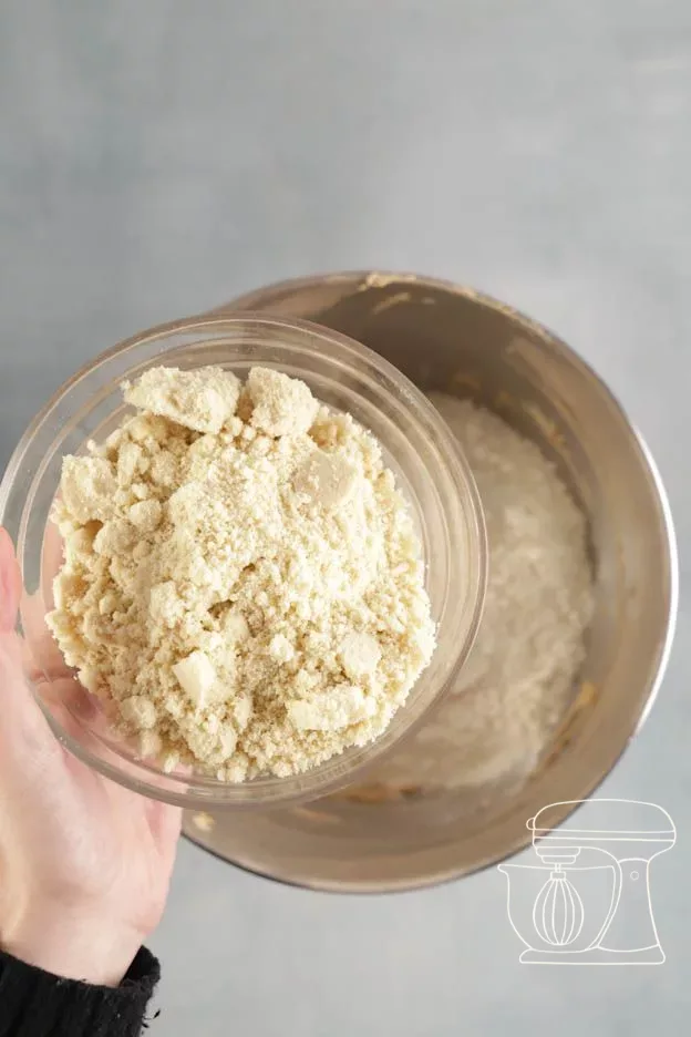 Almond powder being added to the batter