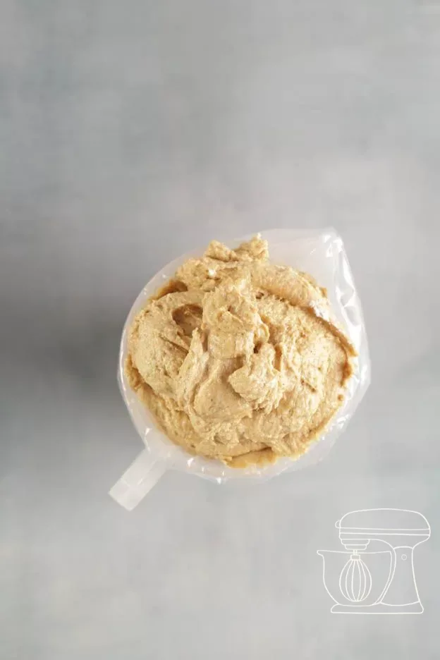 Piping bag is filled using the dough scraper
