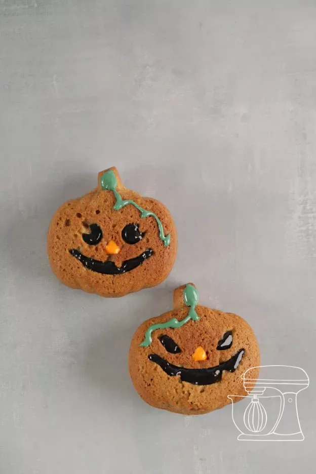 Mini pumpkin cake with a green stem and a black face