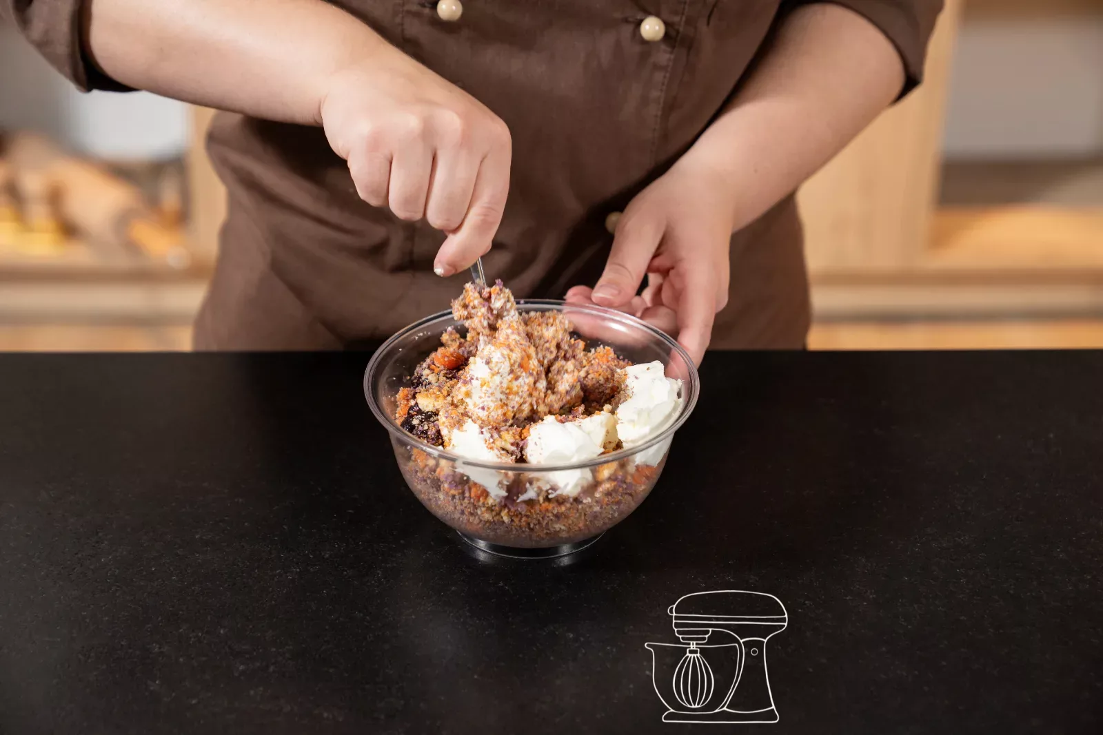 Adding cream cheese and jam to the crumbs