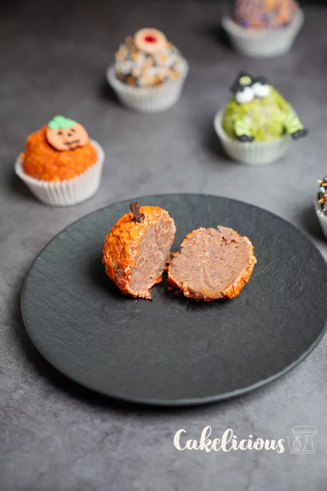 Cut open pumpkin ball with colourful cake pieces inside
