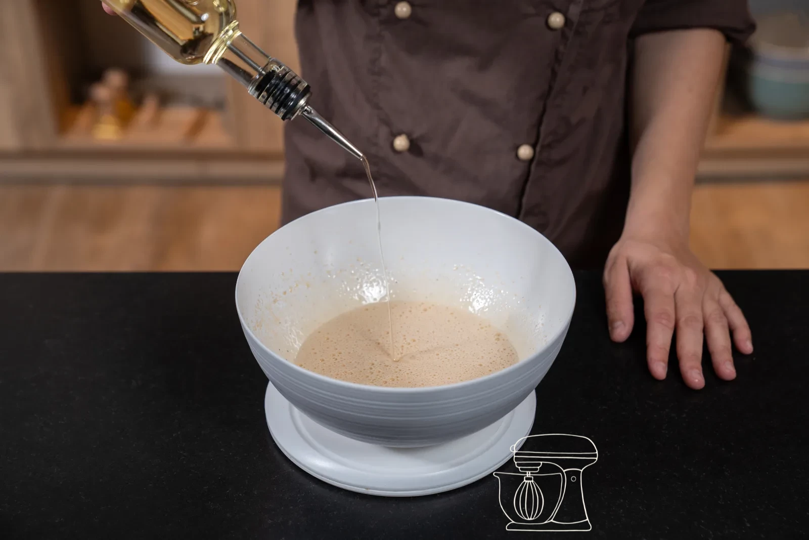 Rapeseed oil and milk being stirred into the whisked egg mixture