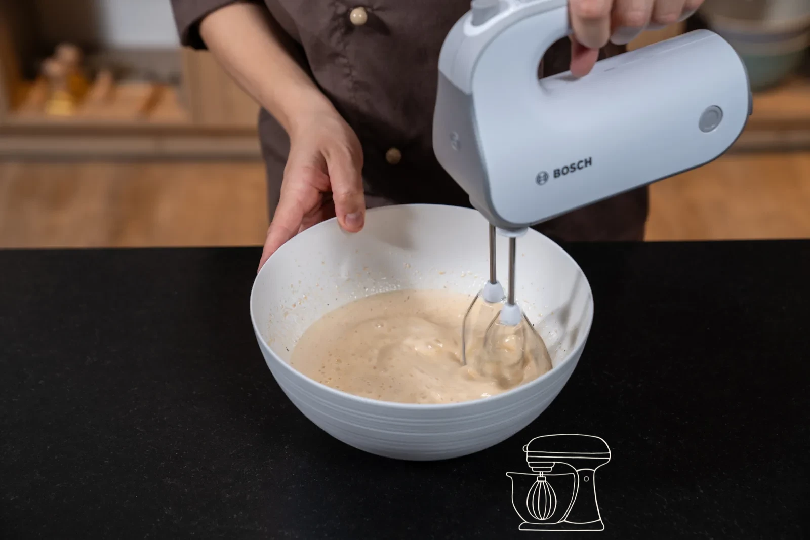 Rapeseed oil and milk being stirred into the whisked egg mixture