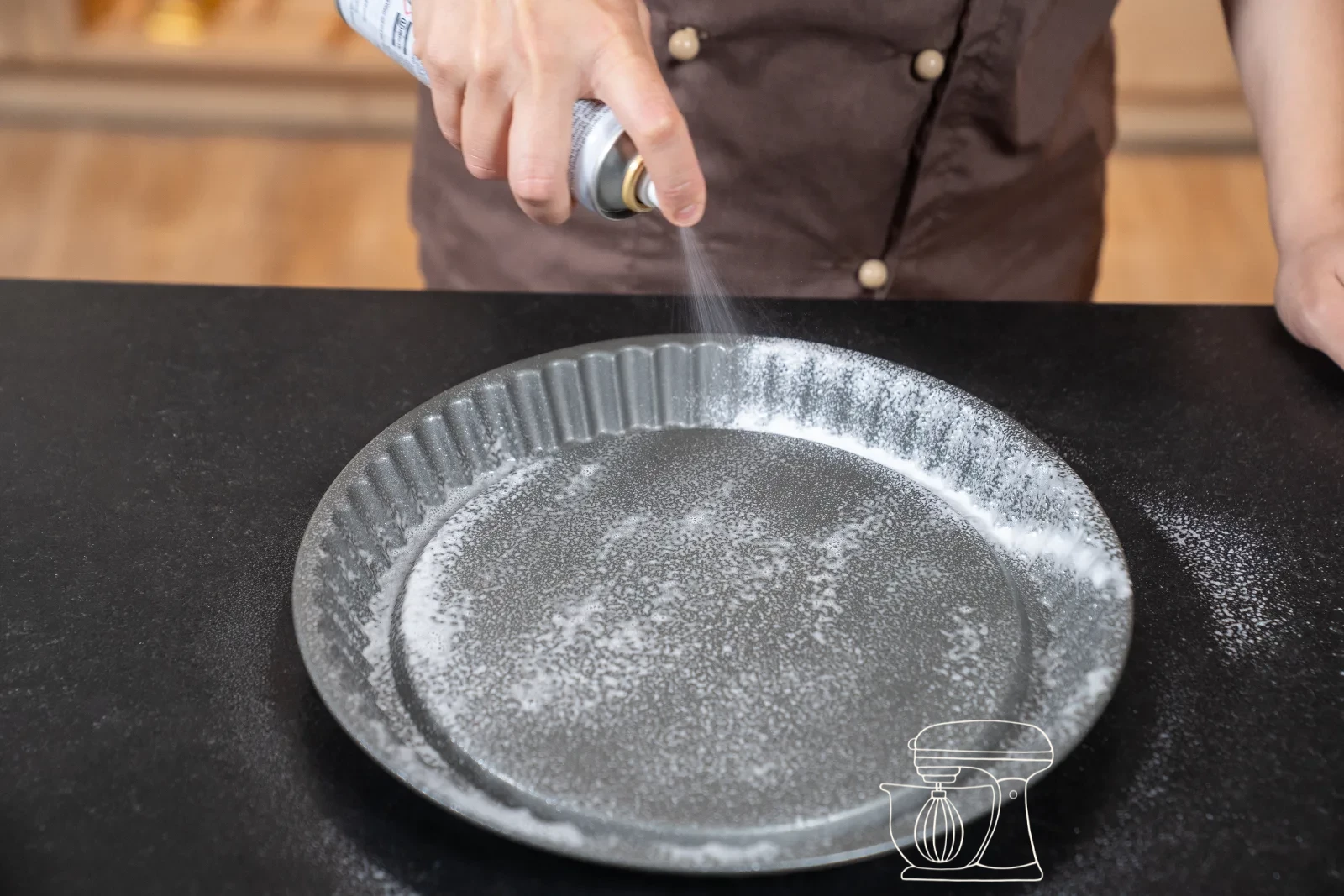 Golden-baked sponge cake base being turned out of the tin, hollow facing up