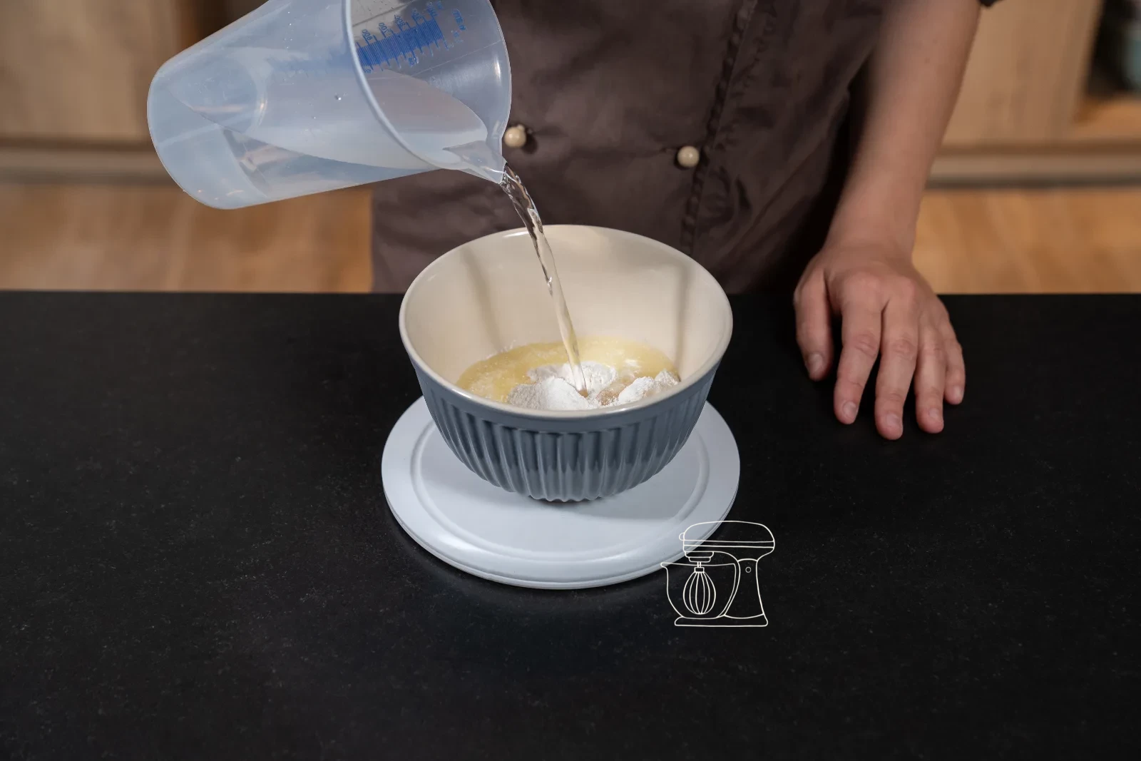 Smooth custard cream being whipped in a bowl with the hand mixer
