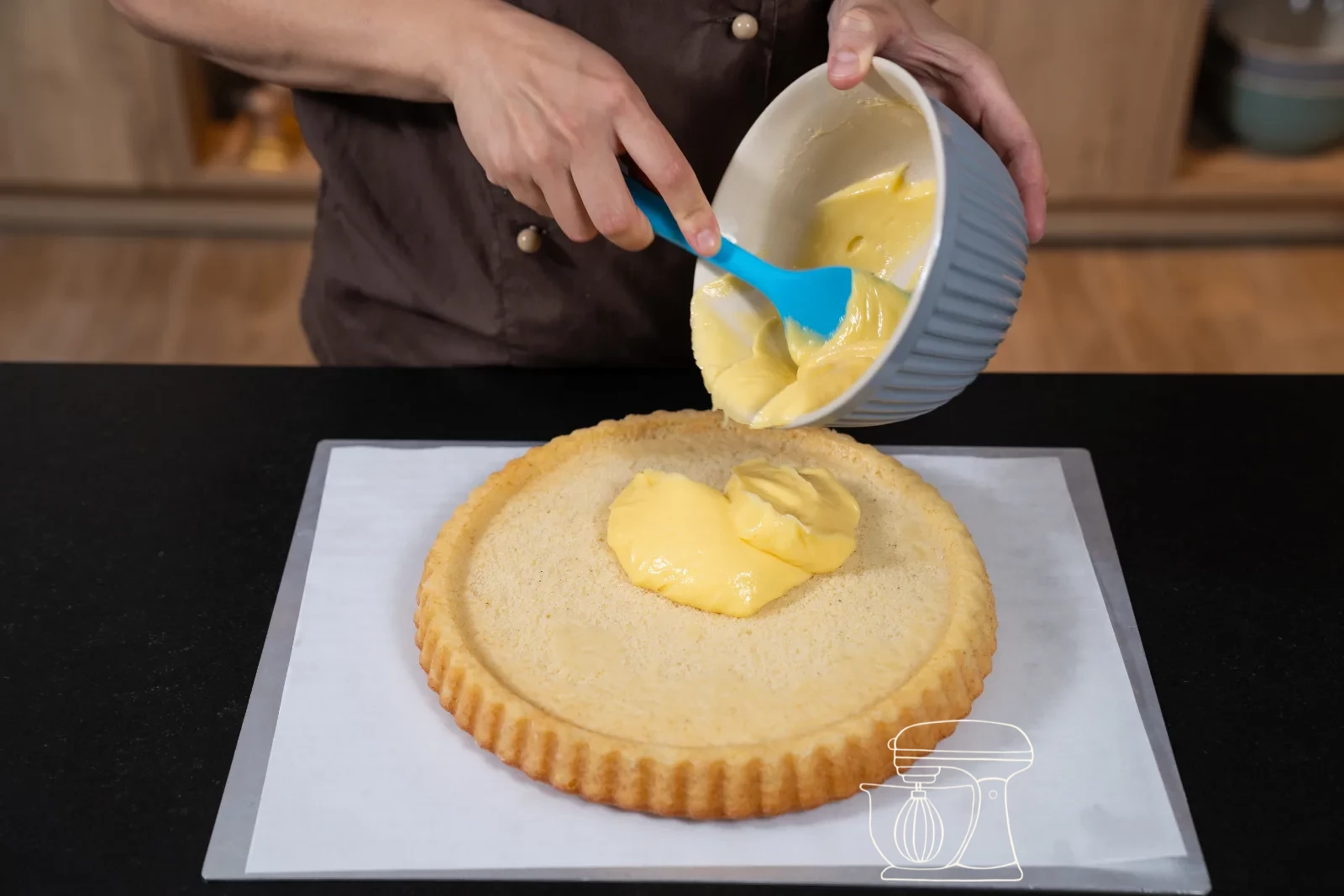 Smooth custard cream being whipped in a bowl with the hand mixer