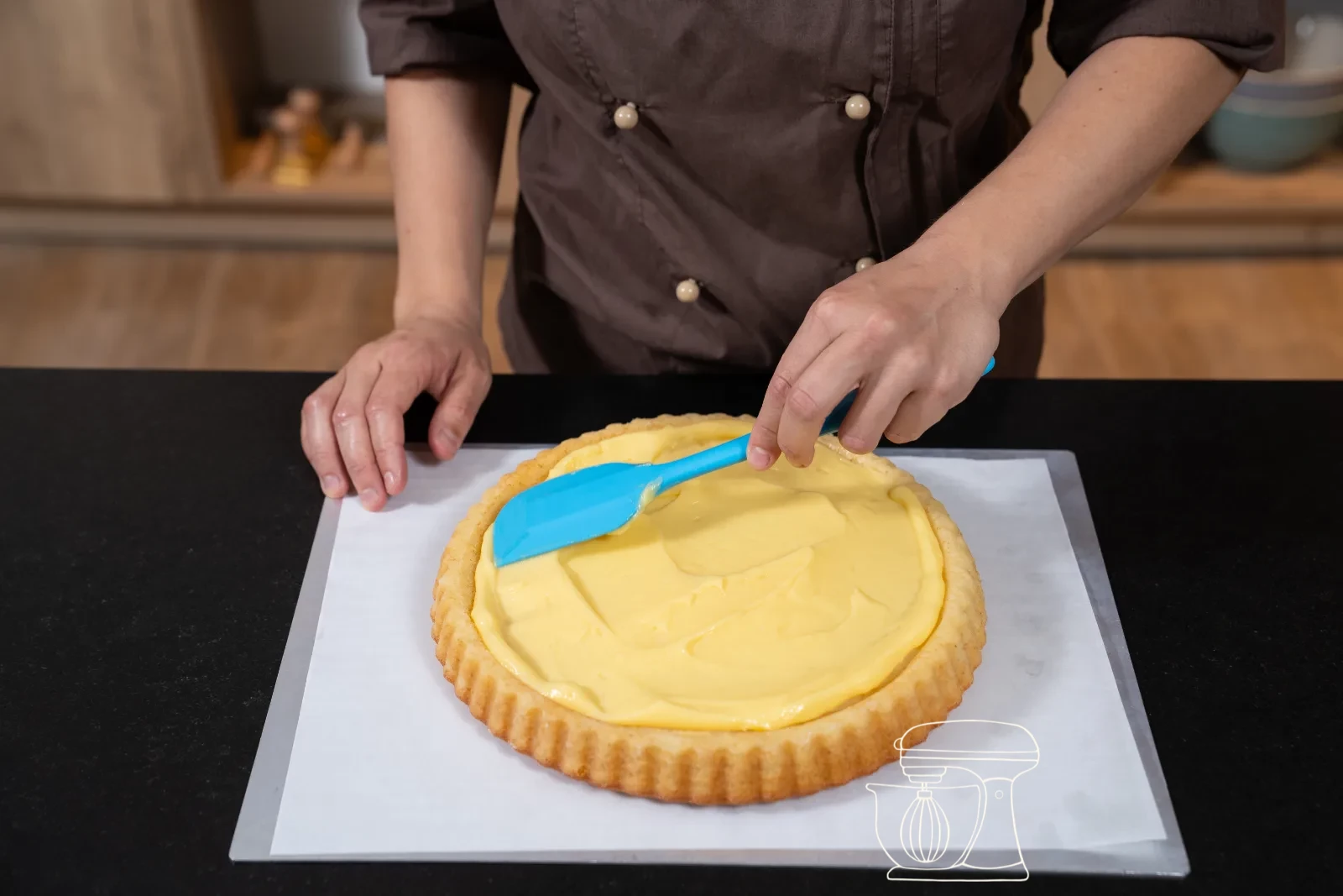 Berries, apricots and grapes being placed densely on the custard cream