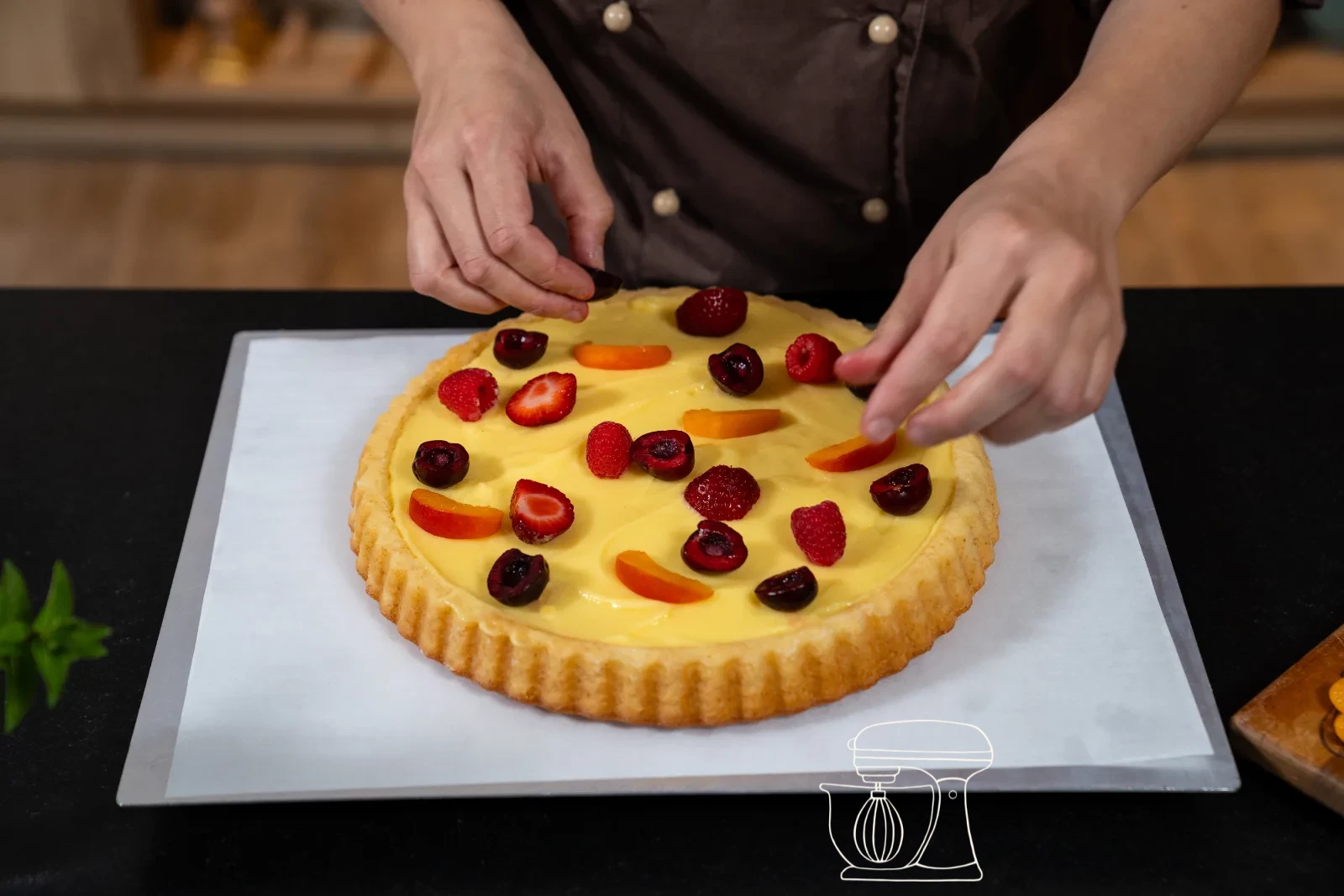 Berries, apricots and grapes being placed densely on the custard cream