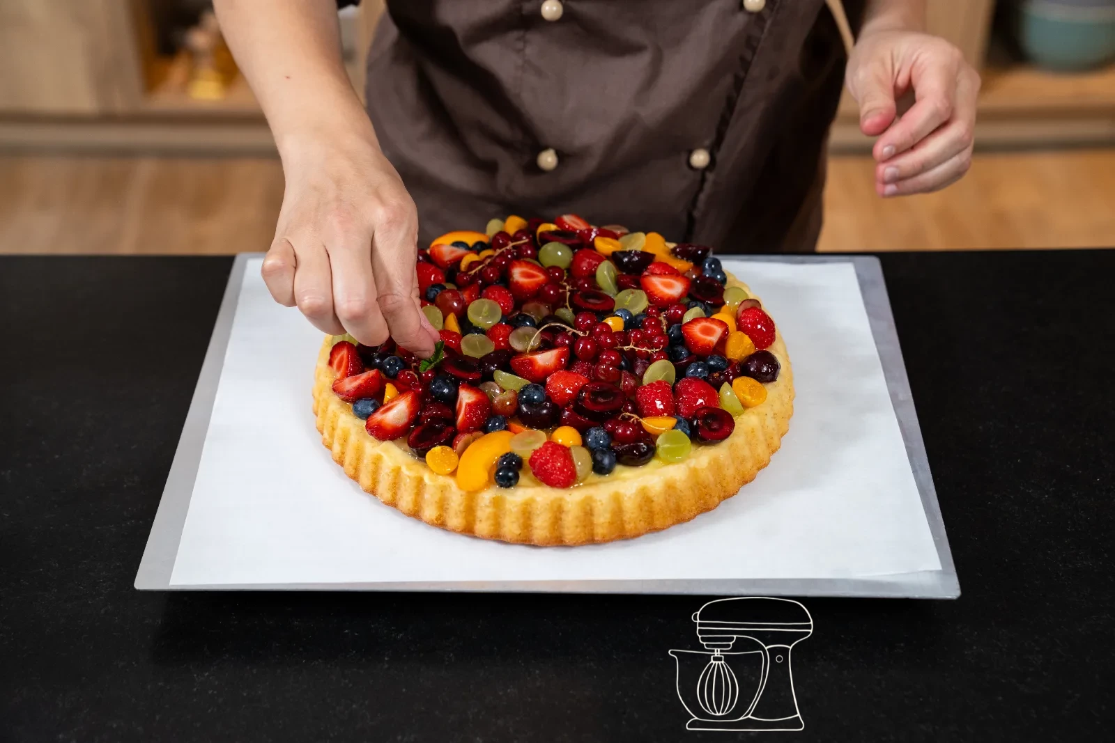 Fruit on the fruit cake being brushed glossy with warm cake glaze