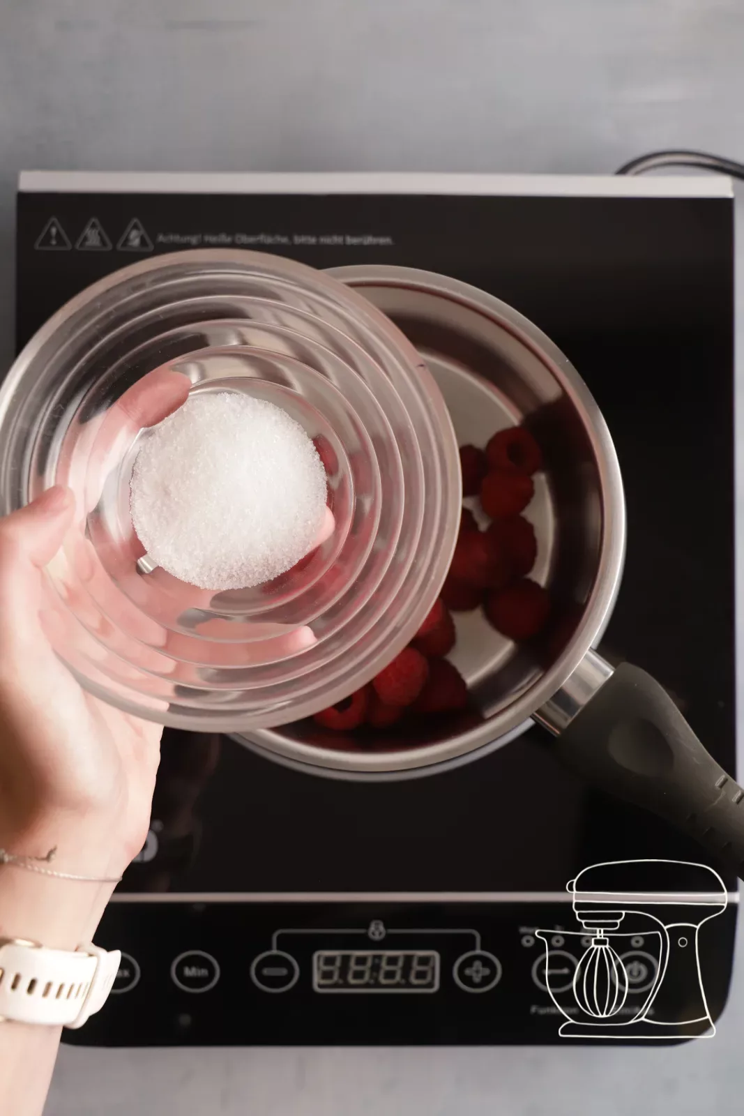 Adding sugar to the raspberries
