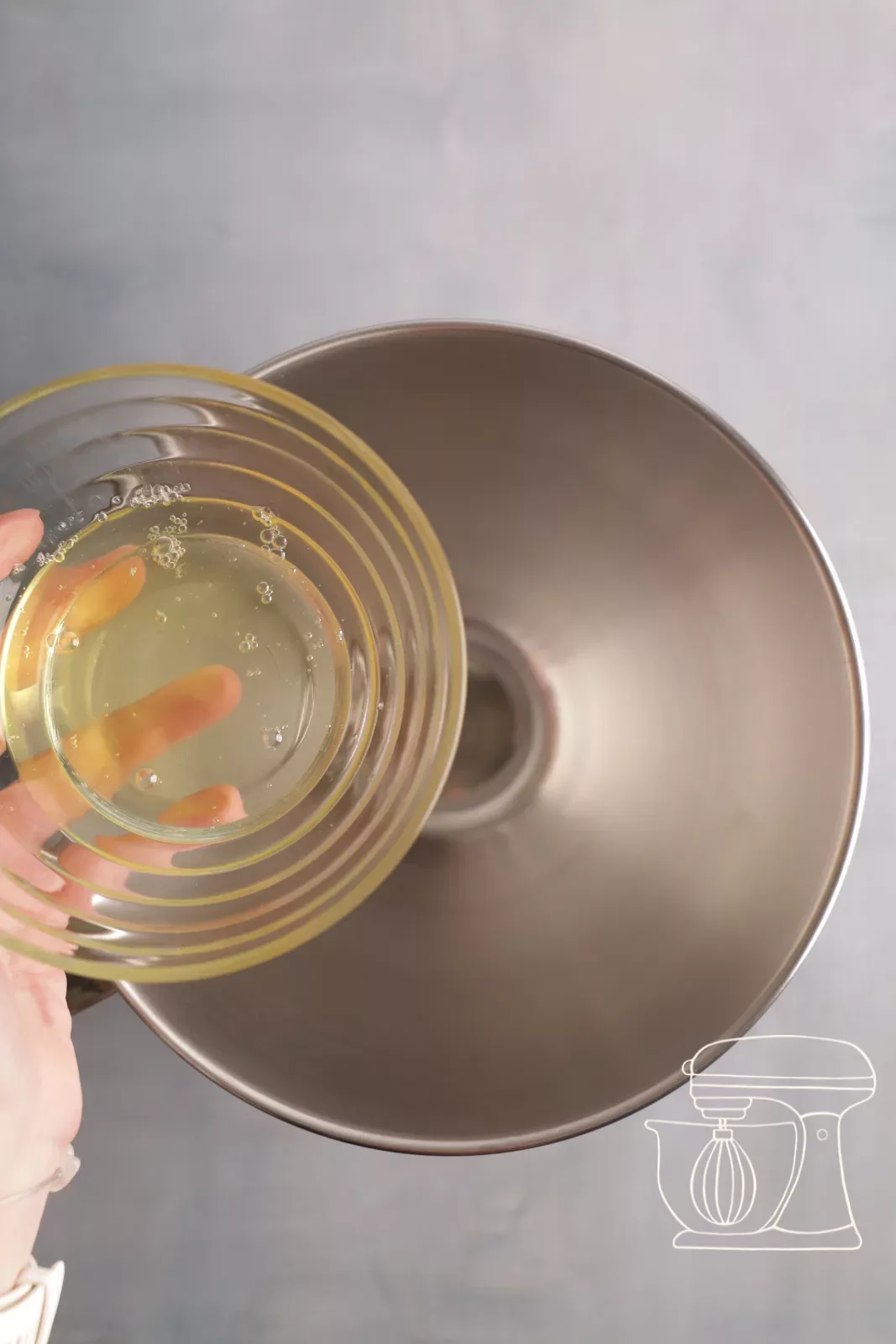 Putting egg whites into the mixing bowl