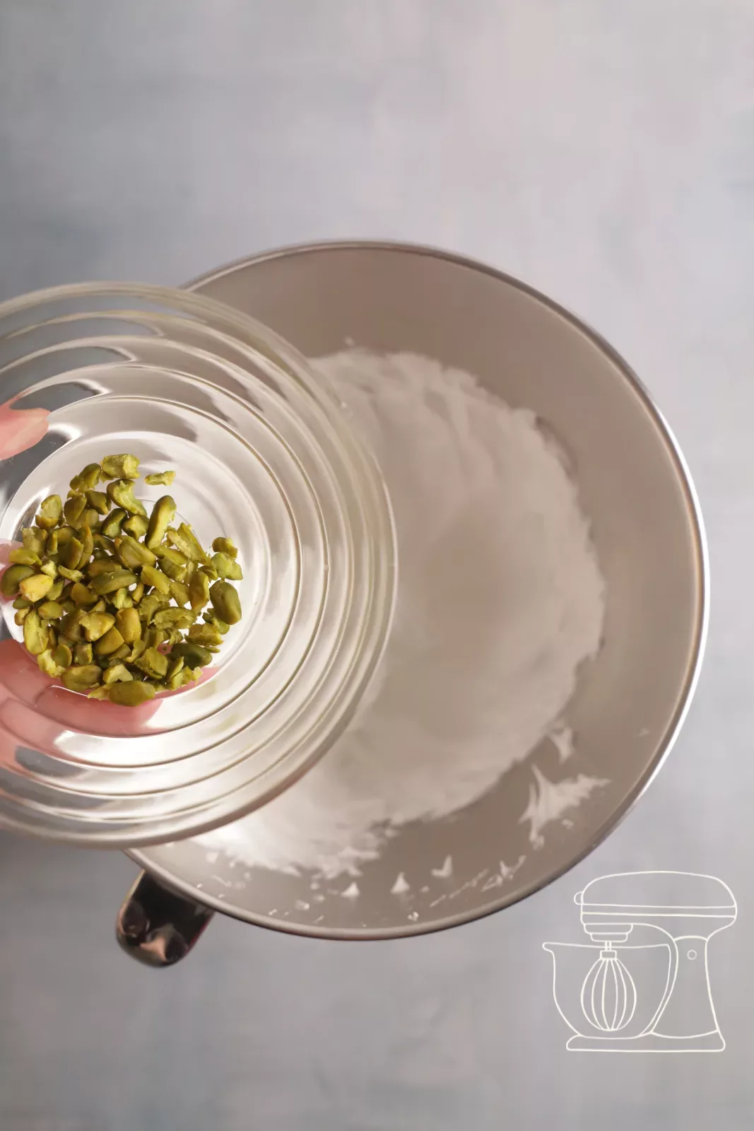 Adding chopped pistachios to the meringue