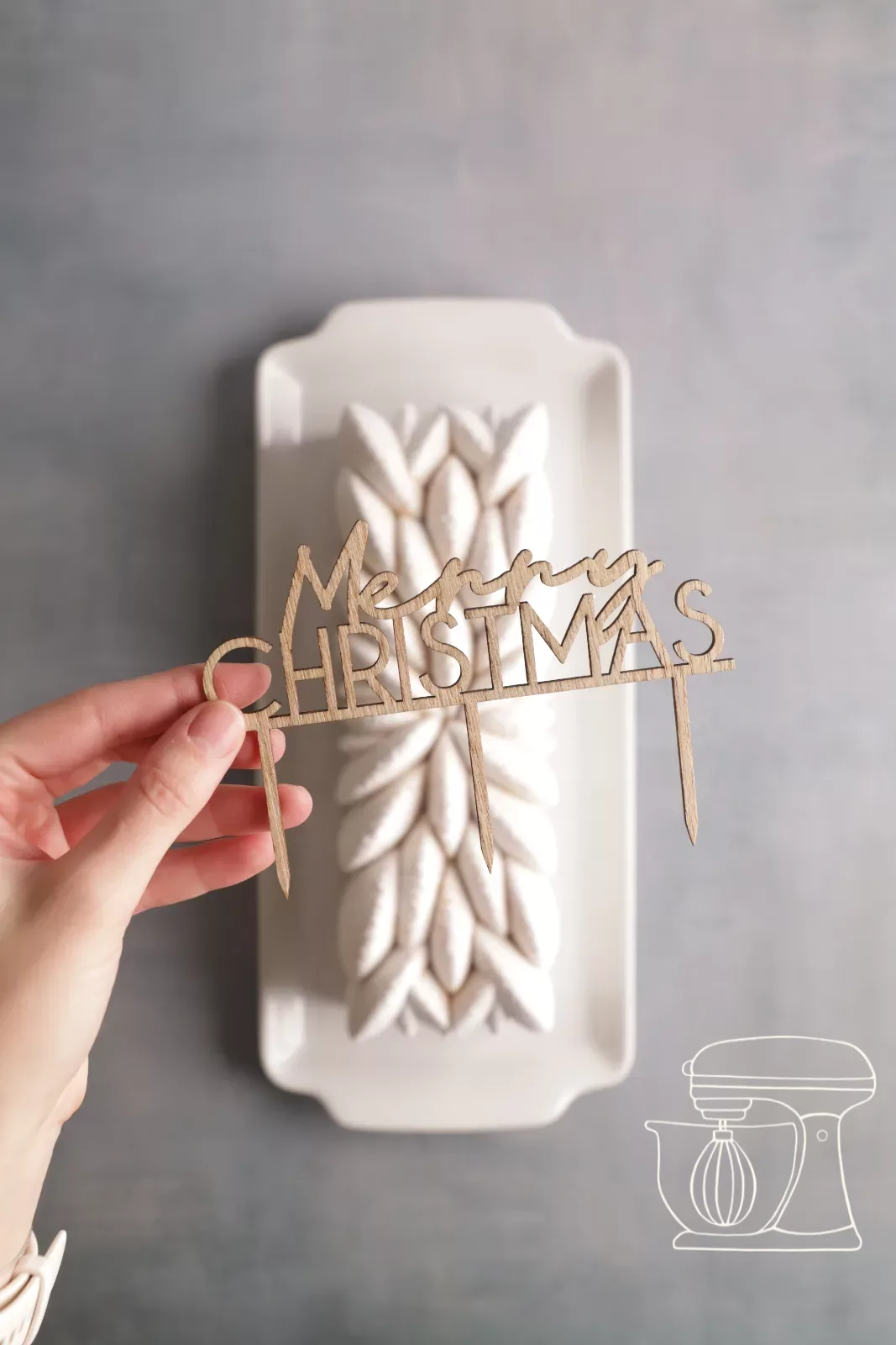 Placing the Merry Christmas cake topper