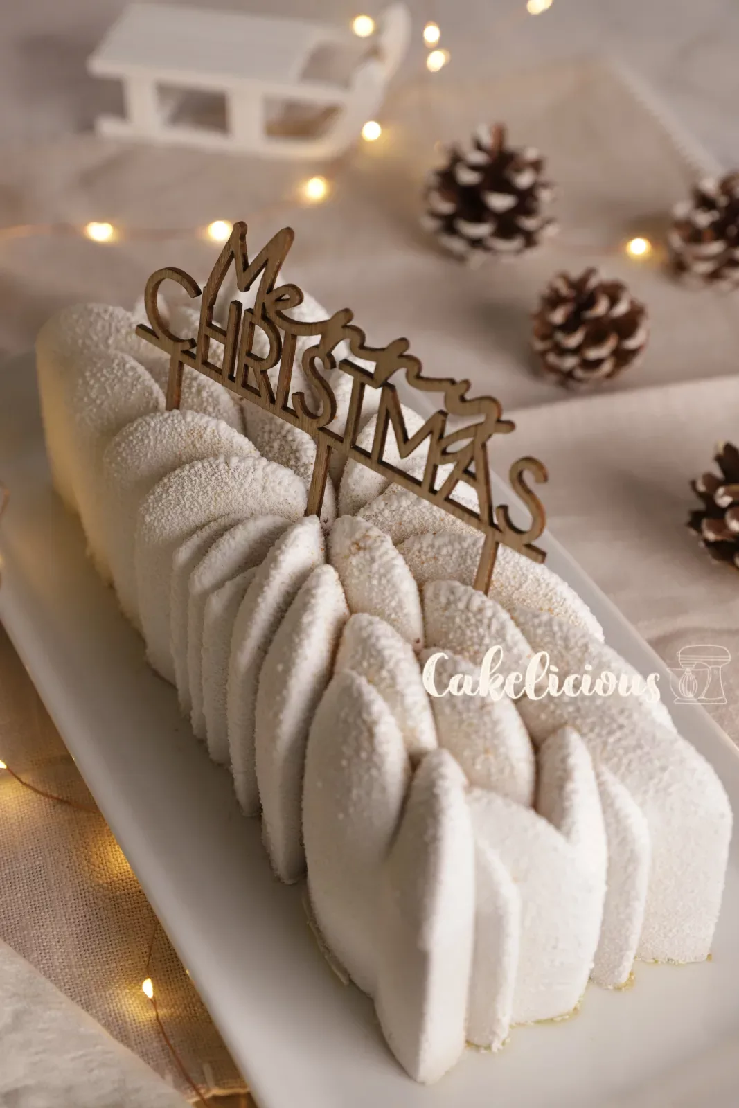 Pistachio raspberry Bûche with pine cones and fairy lights