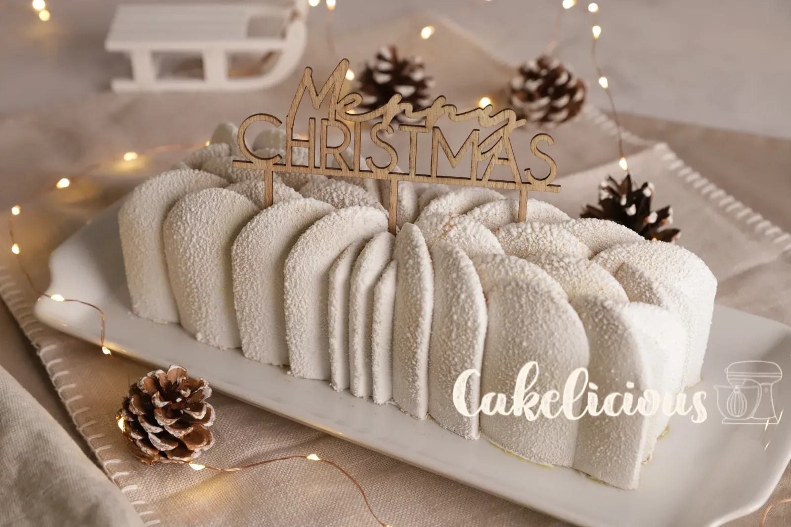 White Bûche with wooden cake topper on a long platter