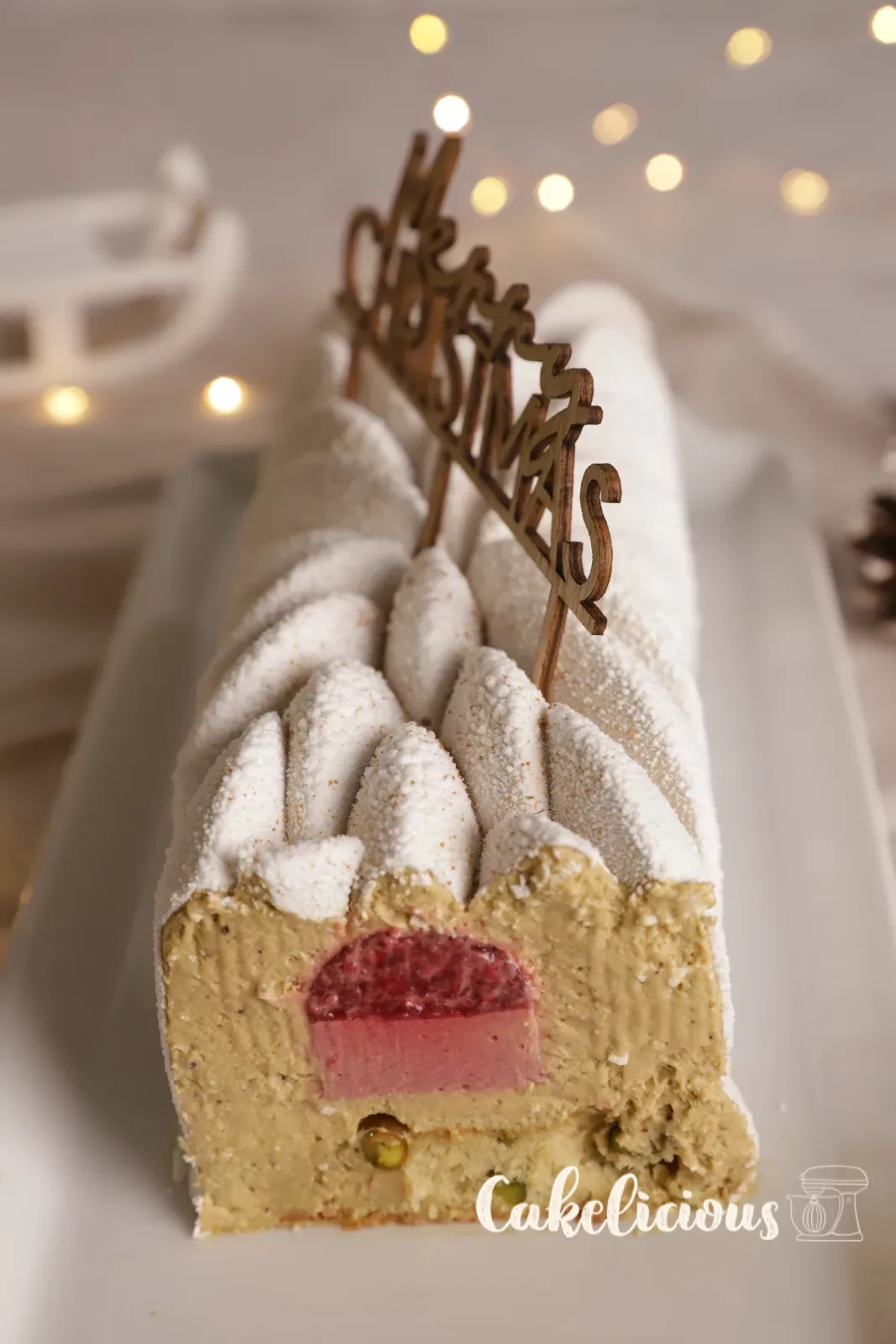 Close-up of the cut showing raspberry compote and pistachio Financier