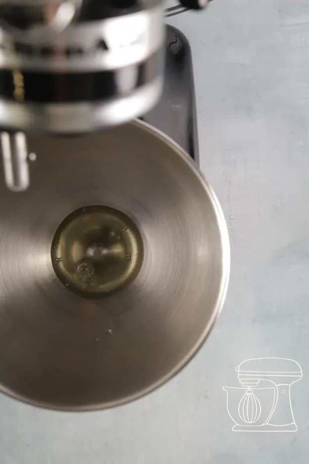 Egg white being whipped to a foam in a mixing bowl with a hand mixer