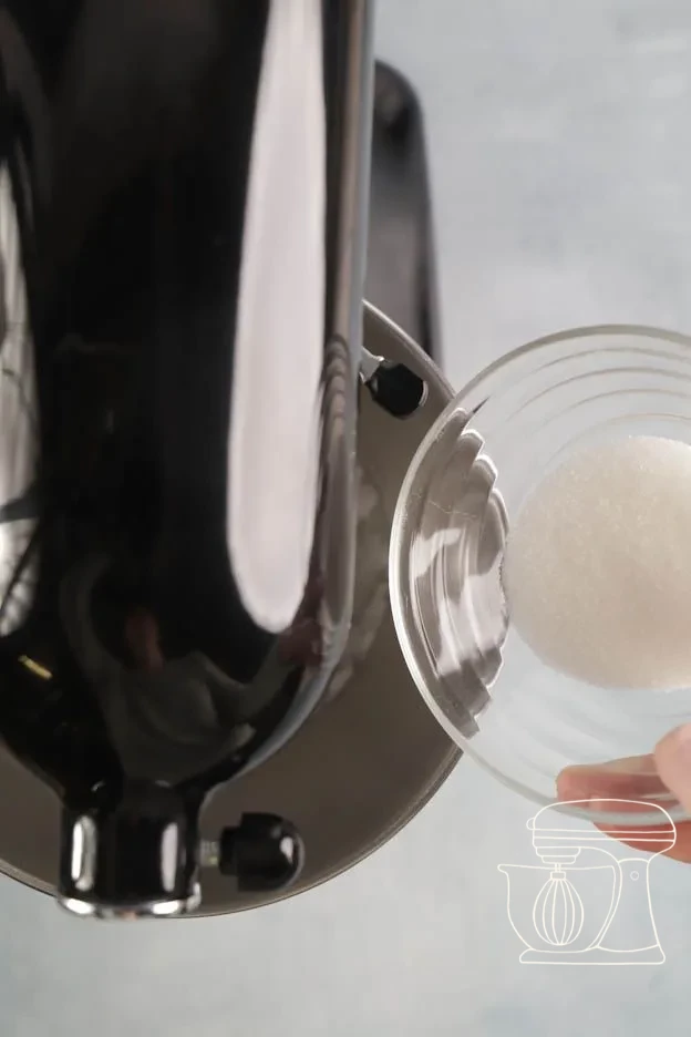 Egg white being whipped to a foam in a mixing bowl with a hand mixer
