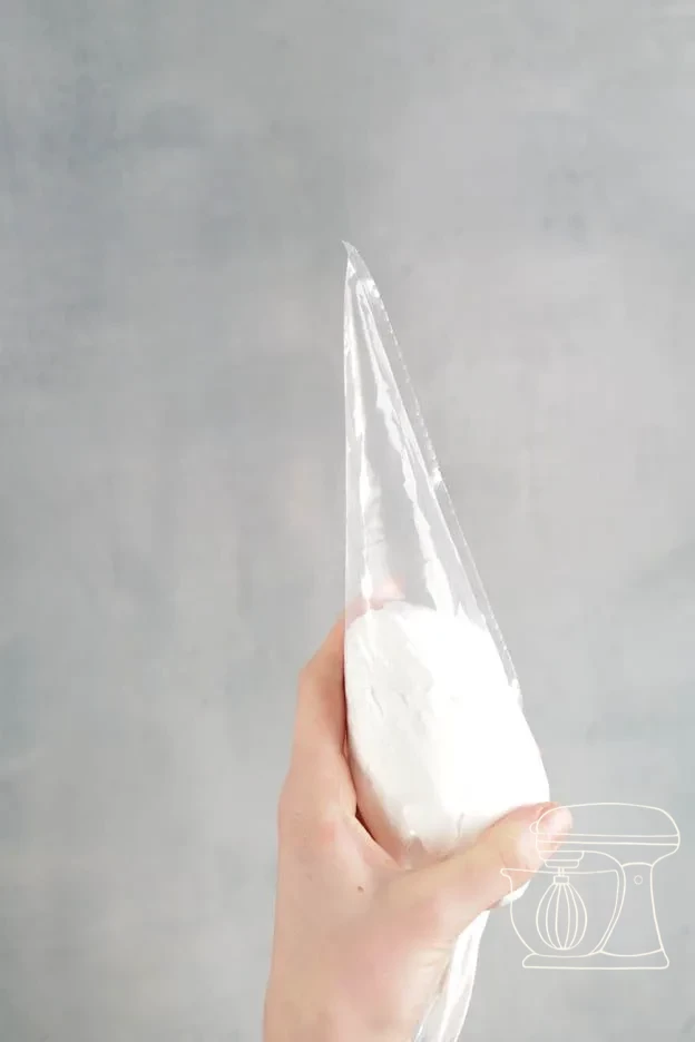 Meringue being piped into the bear silicone mold and smoothed flat