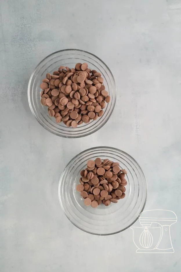 Milk chocolate being melted in a bowl and stirred with the dough scraper