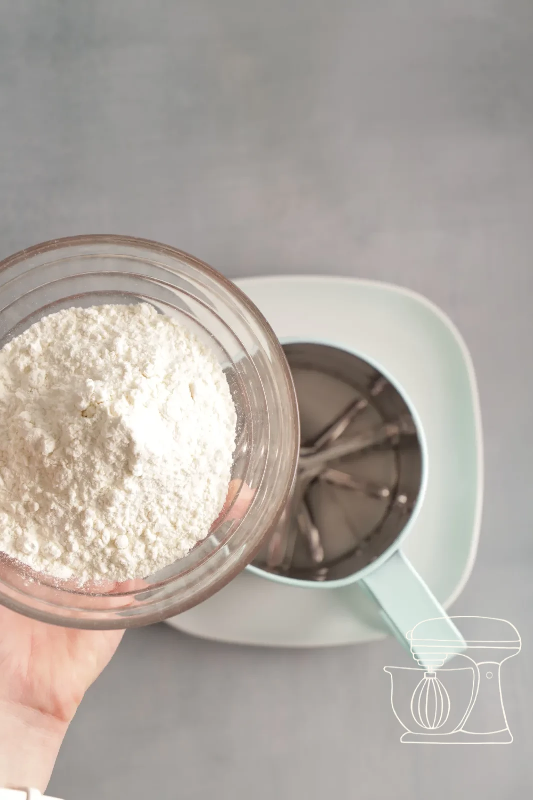 Flour and cocoa being sifted onto the meringue