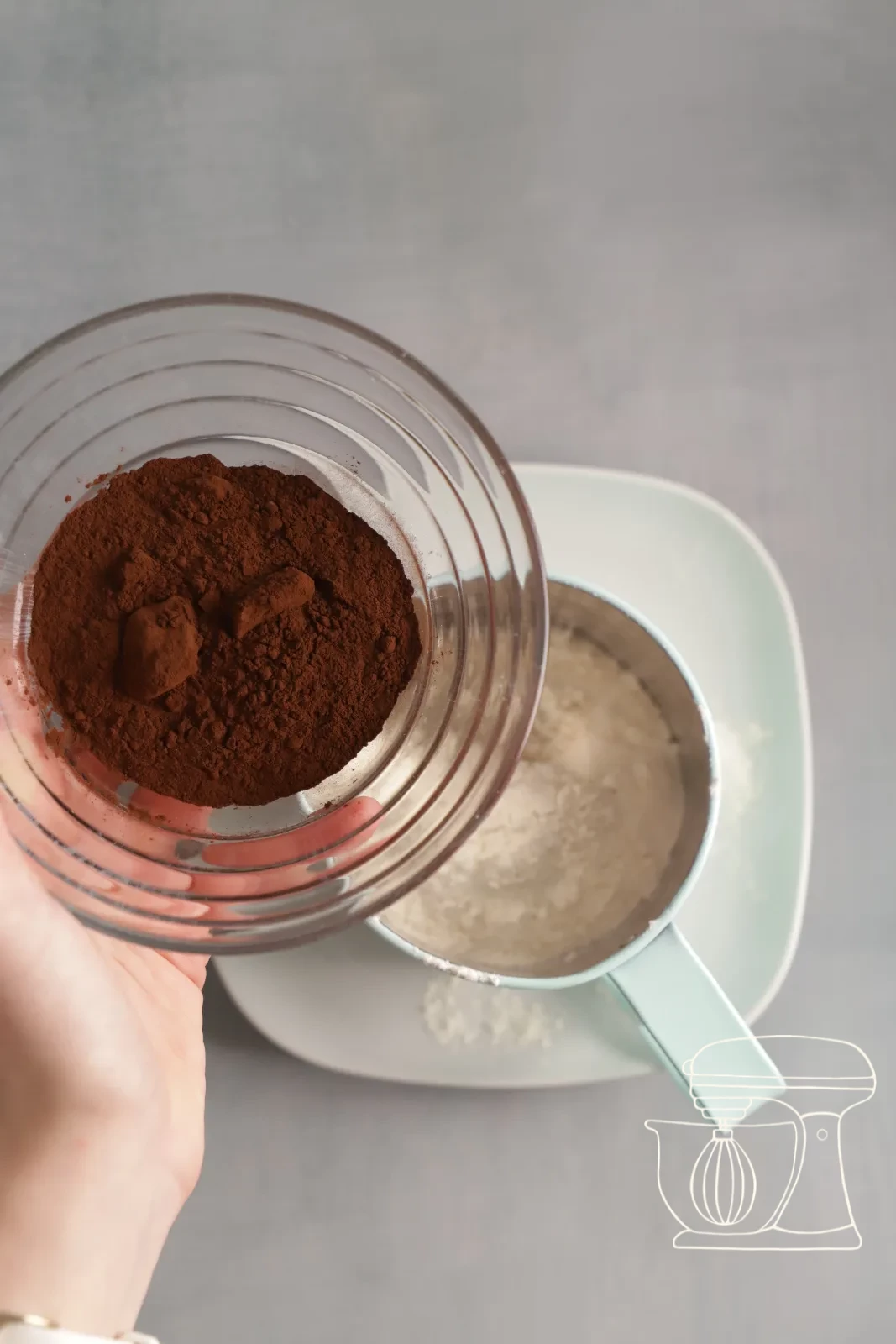 Flour and cocoa being sifted onto the meringue