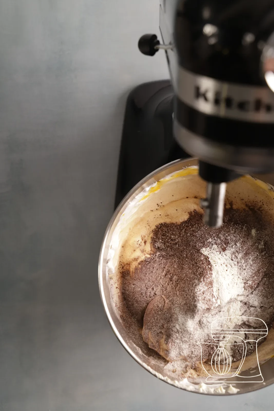 Flour and cocoa being sifted onto the meringue