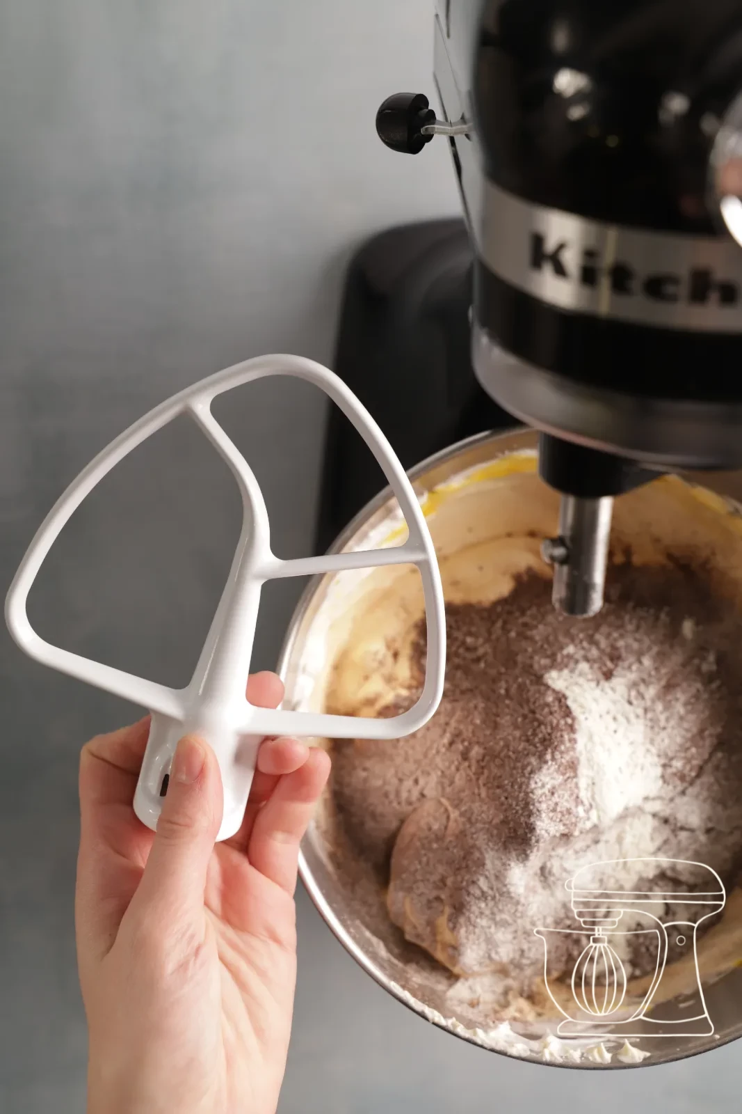The mixture being stirred smooth with the dough scraper