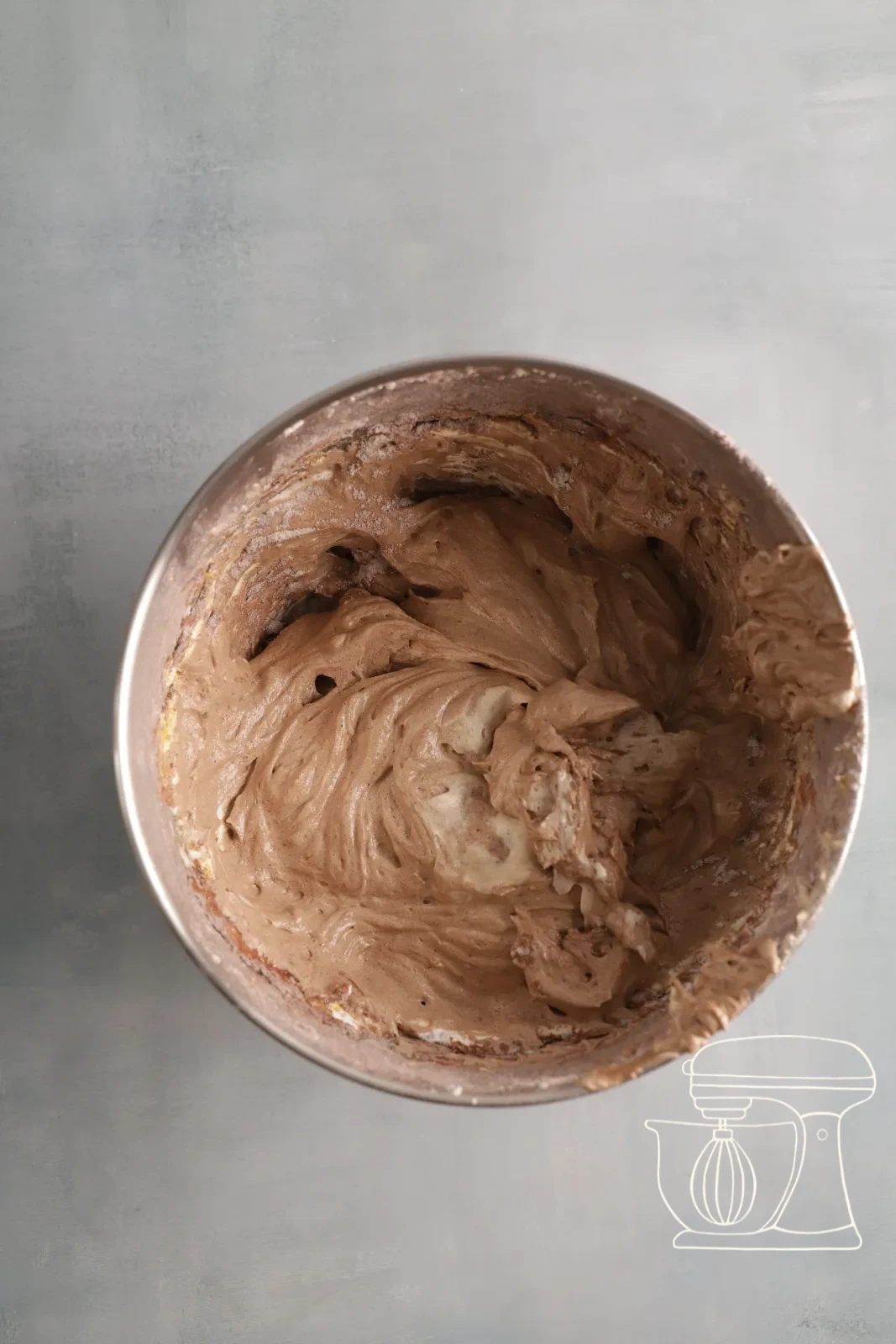 The mixture being stirred smooth with the dough scraper