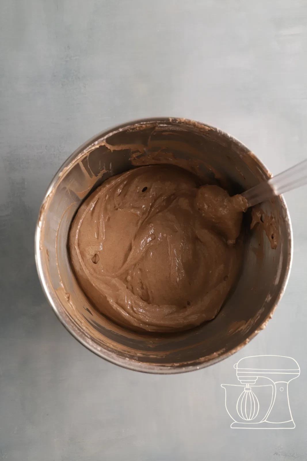 The mixture being stirred smooth with the dough scraper