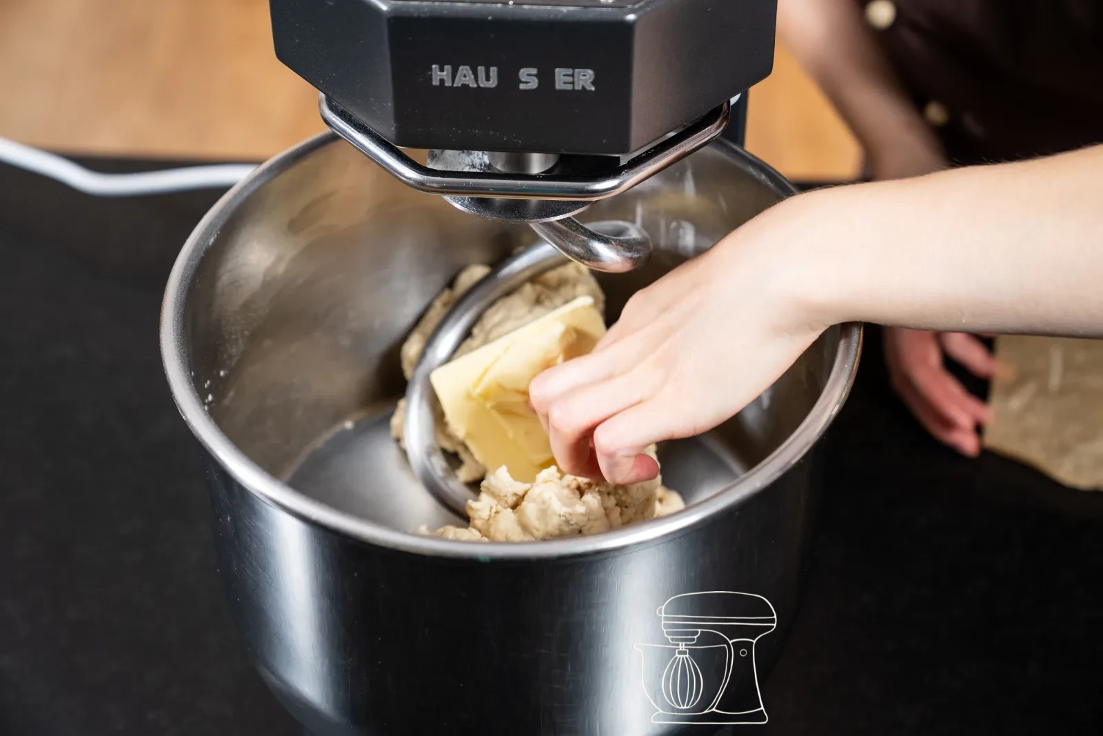 The soft butter is added to the dough
