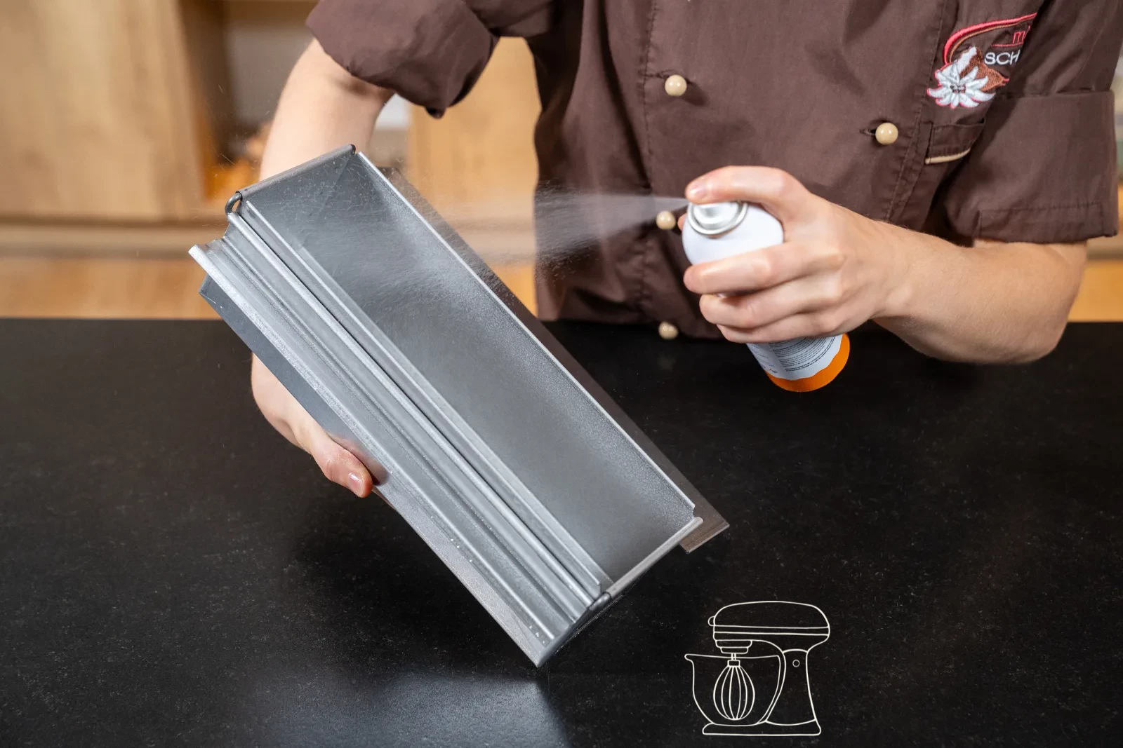The toast baking tin is sprayed with Non-stick spray