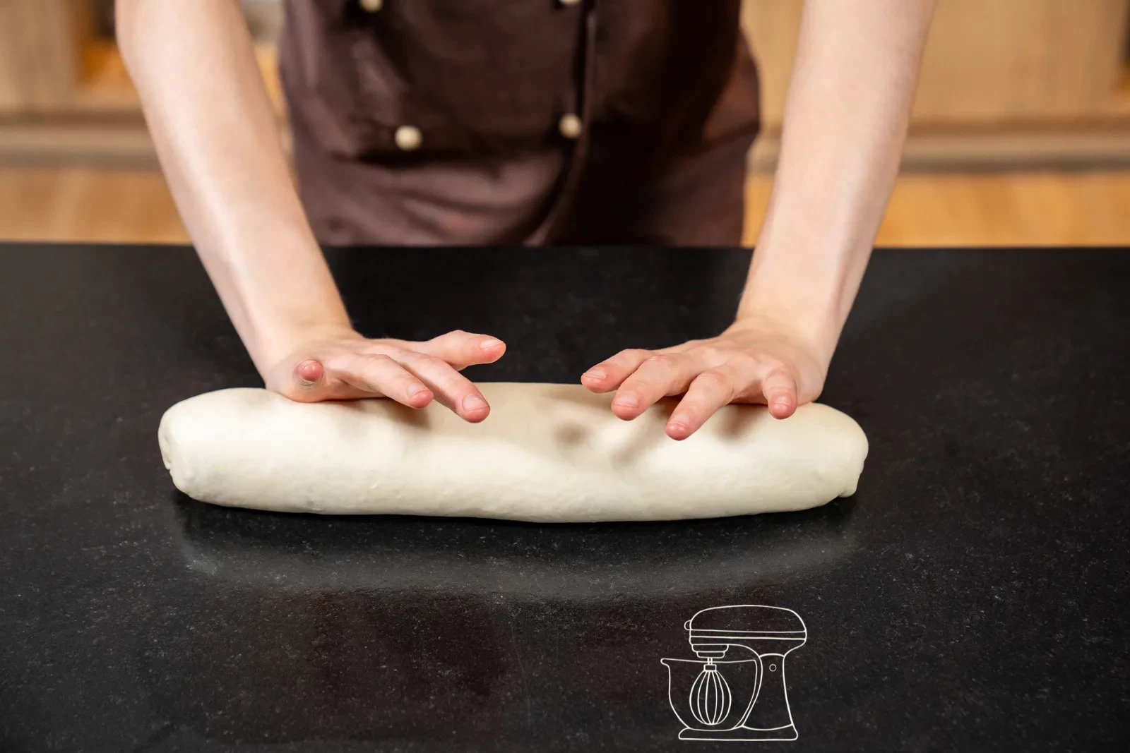 The fully rolled-up shaped dough at tin length