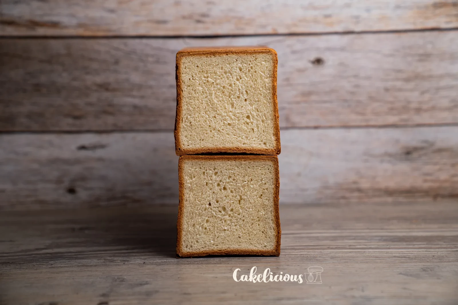 Sliced toast bread on a wooden board with a bread knife