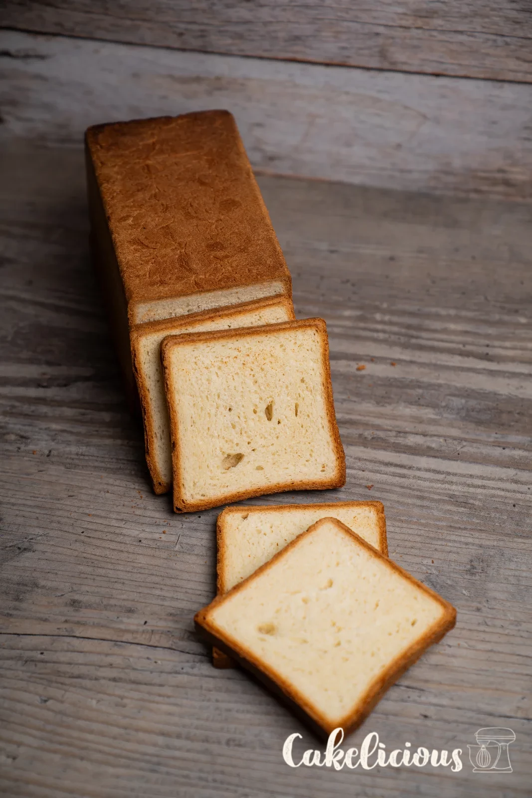 Sliced toast bread on a wooden board with a bread knife
